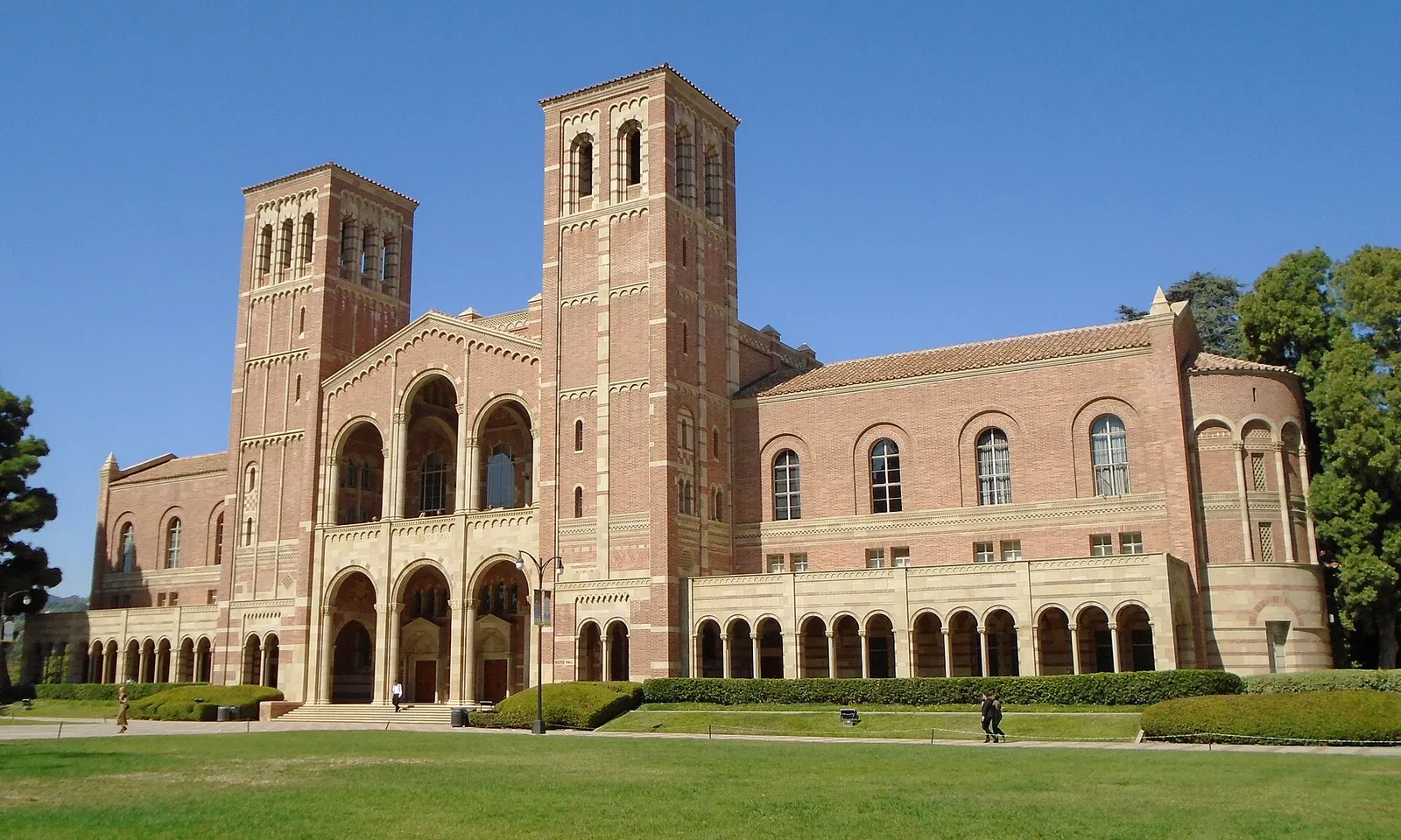 Royce Hall at UCLA, a red brick building with two arched towers, across a green lawn